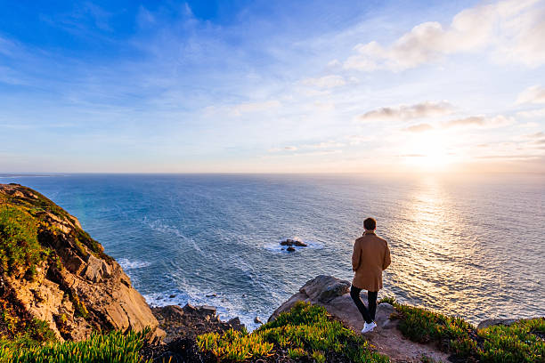 istock The guy is walking on a hilly stony coast with a magnificent vie 2251300673