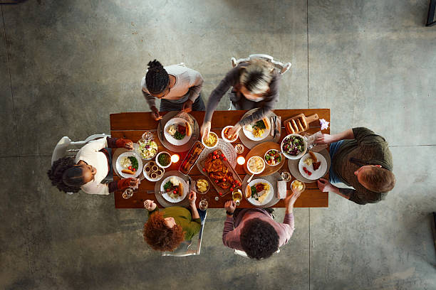 istock Above view of young friends having lunch at dining table. 2251302201