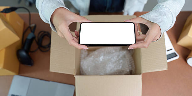 istock E-commerce: Unboxing Experience with Smartphone in Hand 2251302654