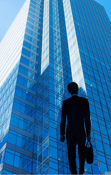 istock Businessman and office tower 2251305946