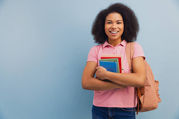 istock African American student smiling holding books and backpack 2251309439