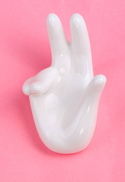 istock Ceramic stand with hand shape on pink background 2251309578