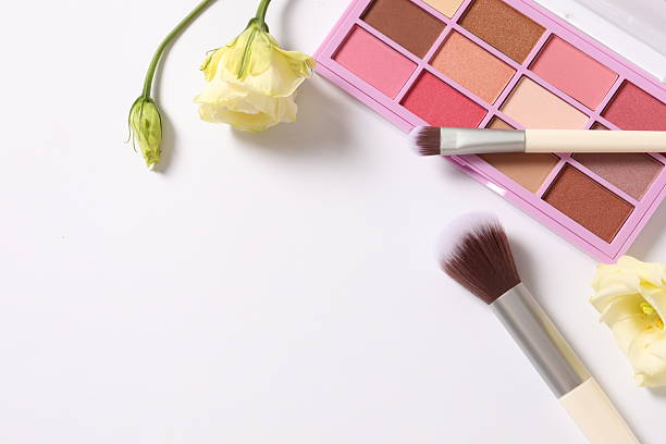 Set of decorative cosmetics with flowers on a white background