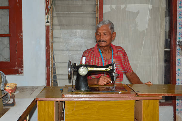 istock Elderly Man Working Diligently at His Vintage Sewing Machine 2251310462