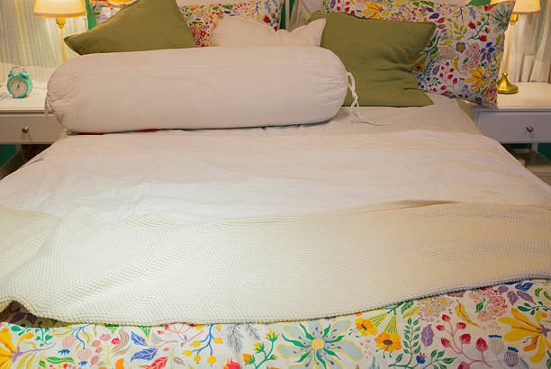 istock bed with pillows and bedclothes in hotel bedroom, interior design 2251311451