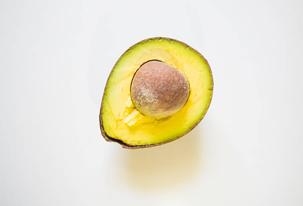 Avocado sliced seed pile fall drop slide scatter splash.