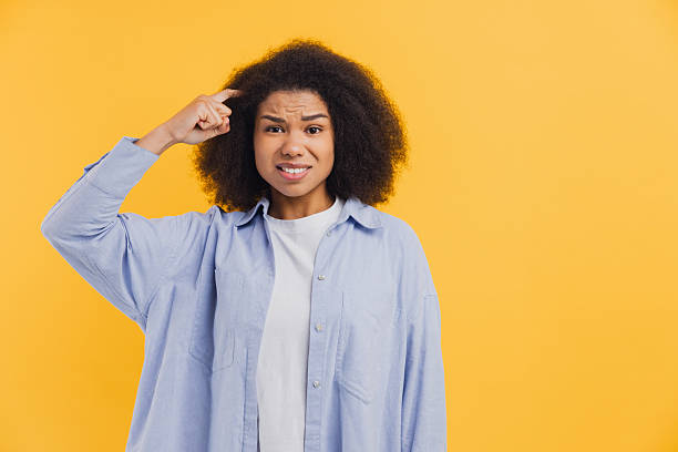 istock African American woman feeling confused scratching head 2251314551
