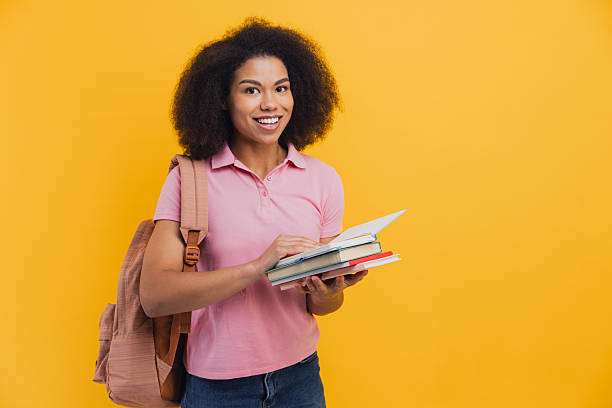 istock African American student smiling holding books and backpack 2251315144
