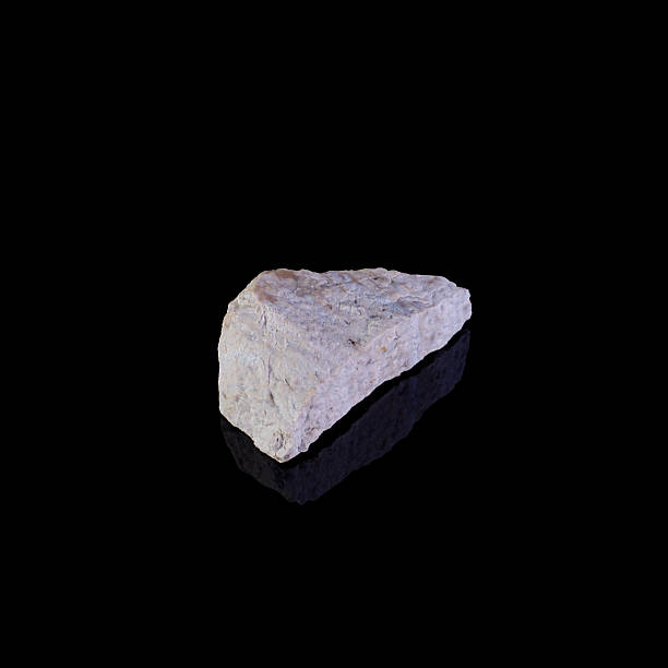 istock A single piece of light-colored rock on a reflective black surface 2251315844