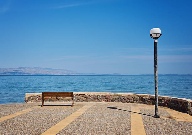 bench and lantern on the embankment of the sea