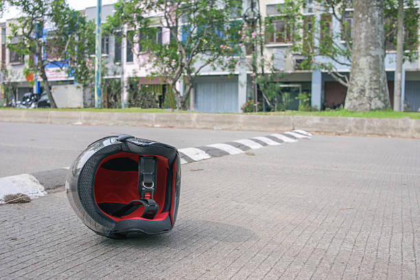 July 1, 2025 Lithuania Kaunas. Road traffic accident on Karaliaus Mindaugo Avenue in Kaunas. A motorcycle is lying on the road and a traffic inspector and a policeman are standing next to the motorcycle.