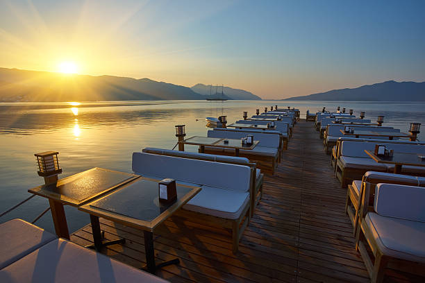 istock Beach cafe at dawn. Empty tables in a cafe, a sunny morning on the beach. 2251324594