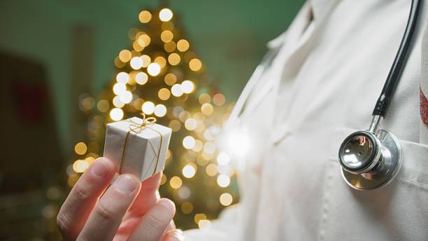 istock Private Anonymous Doctor Gives a Small Box to His Patients Under Treatment 2251325816