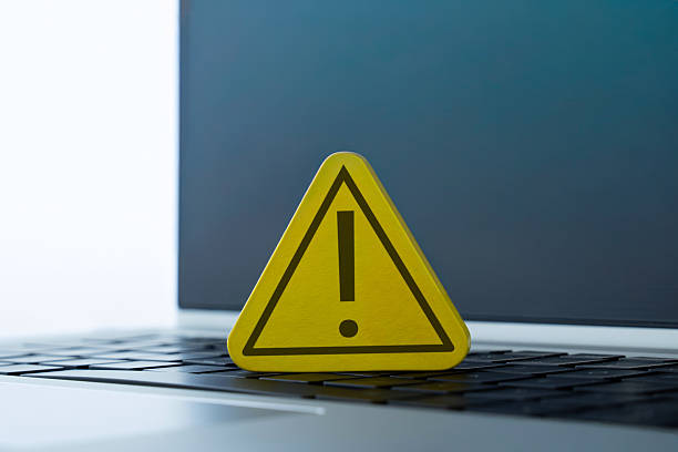 istock A yellow warning sign with an exclamation mark placed on a laptop. 2251327272