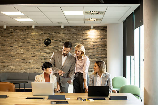 istock Team collaboration in modern office during business meeting with laptops and tablets 2251331510