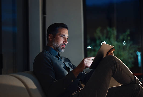 istock Evening Work On Tablet: Professional Man Relaxing On Sofa After Office Hours 2251332217