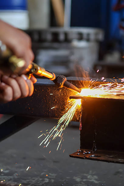istock A hand holds a brass cutting torch, generating intense flame and bright sparks 2251334673