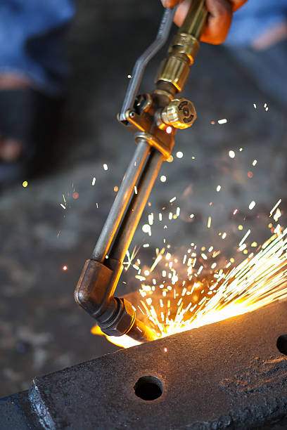 istock A hand holds a brass cutting torch, generating intense flame and bright sparks 2251334765