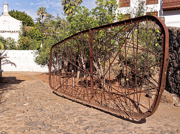 istock Rustic rusty metal gate in cobblestone garden 2251337569