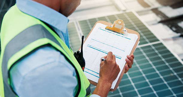 istock Solar panels, writing and hands with checklist, review power production and grid condition. Inspection, above and person with clipboard of maintenance report, monitor system and clean energy function 2251340494