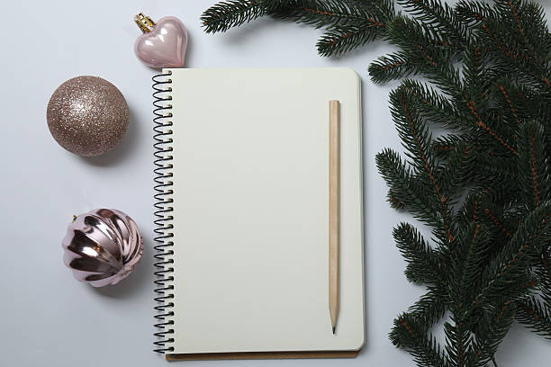 istock new year and christmas background with notebook, christmas tree and decorations on white background, top view, copy space. 2251341595