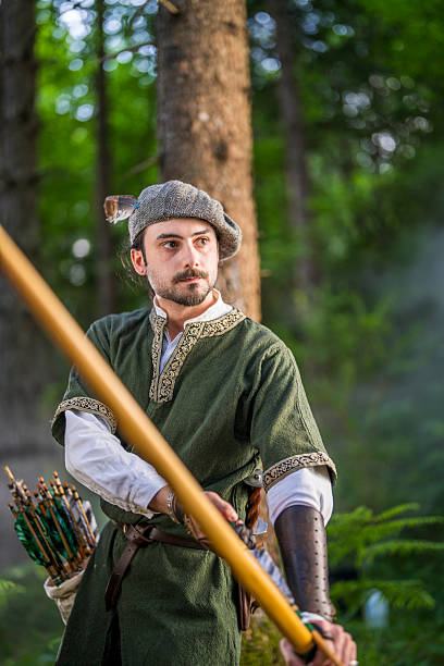istock Focused Young Caucasian Medieval Archer in Forest Setting Holding Bow 2251342471