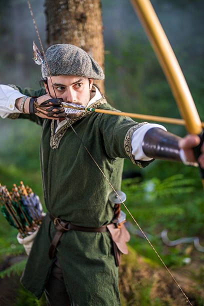 istock Young Caucasian Archer Poised with Bow in Serene Forest Setting 2251342477