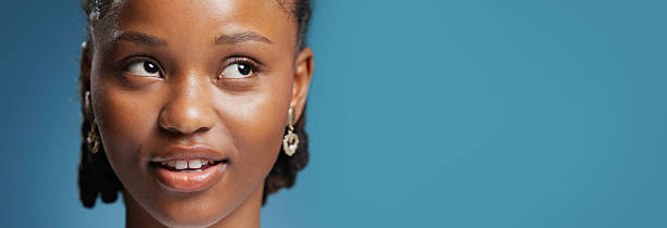 Thinking, decision and black woman in studio, choice and contemplation on blue background. Mockup space, thoughtful or African person with wonder, planning or problem solving with solution or banner