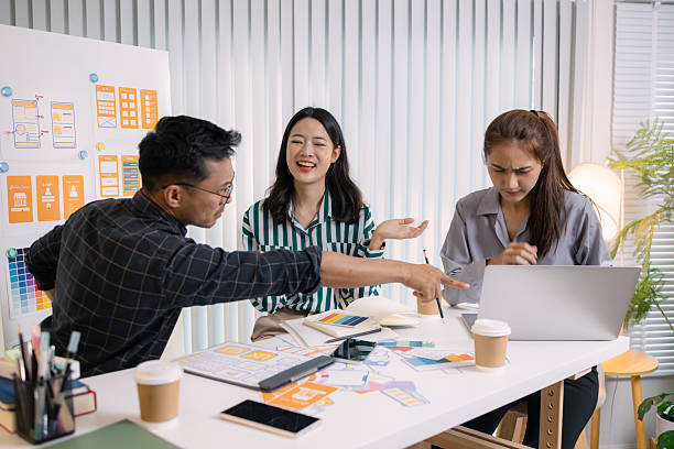 istock UX/UI designers presenting their final design project to the team, showcasing app interface screens and explaining user experience strategies in a professional creative office environment. 2251346787