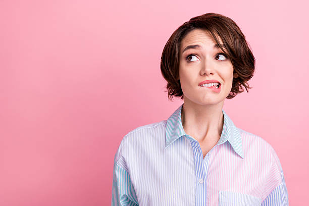 istock Photo portrait woman got problem looking empty space biting lip isolated pastel pink color background 2251346878