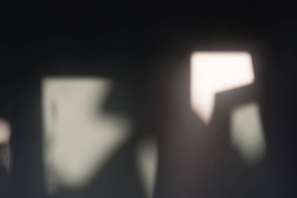 istock Abstract Blurred Light and Shadow Shapes on Dark Wall 2251347735