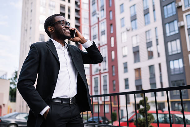 istock Handsome businessman getting good news while using a smartphone, looking to the side 2251348915