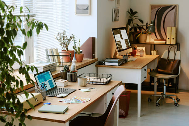 istock Modern Office Workspace Featuring Laptops and Monitors on Wooden Desks 2251349306