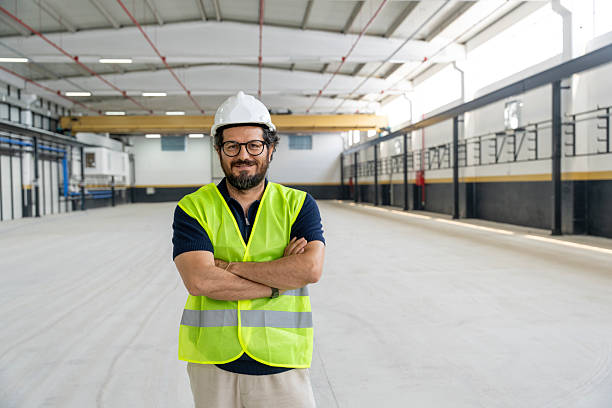 istock Engineer in Hard Hat with Arms Crossed at Factory Site 2251350410