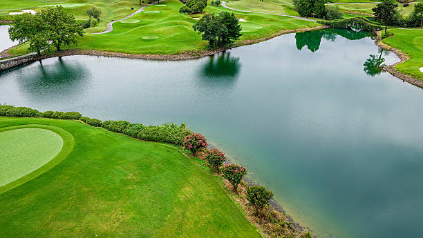 istock Beautiful green golf course landscape and lake reflection. 2251351489
