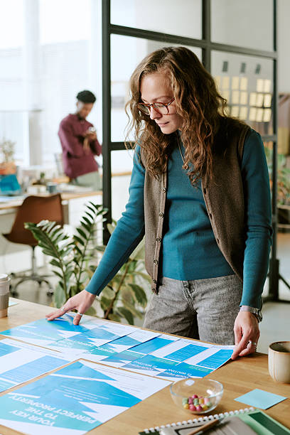 istock Caucasian Young Adult Woman Analyzing Documents during Office Meeting 2251352100