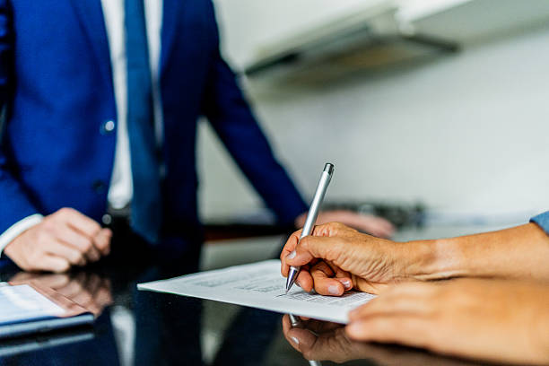 istock Close-up of customer woman signing document 2251355447