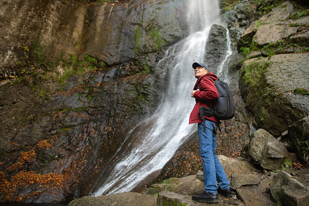 istock Senior man enjoying nature near waterfall 2251355848