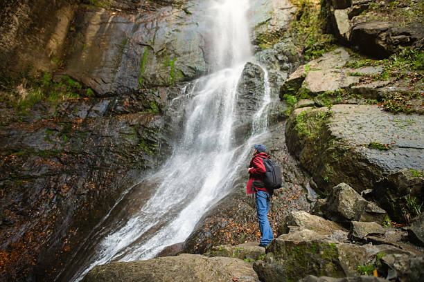 istock Senior man enjoying nature near waterfall 2251355906