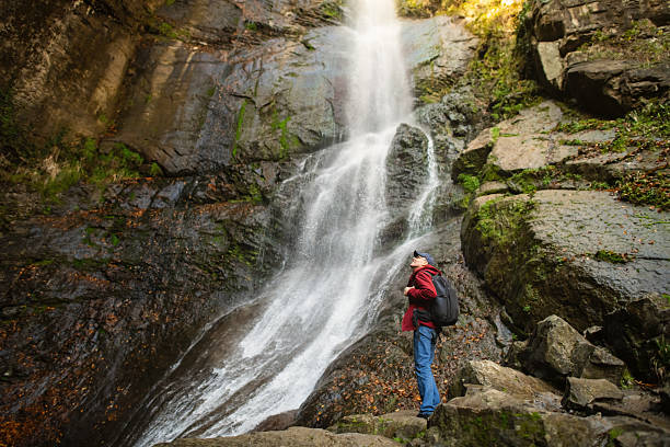 istock Senior man enjoying nature near waterfall 2251355911