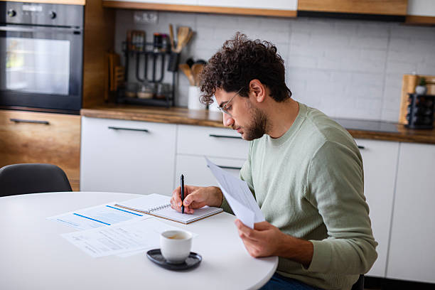 istock Man Reviewing Tax Papers and Financial Documents 2251359856