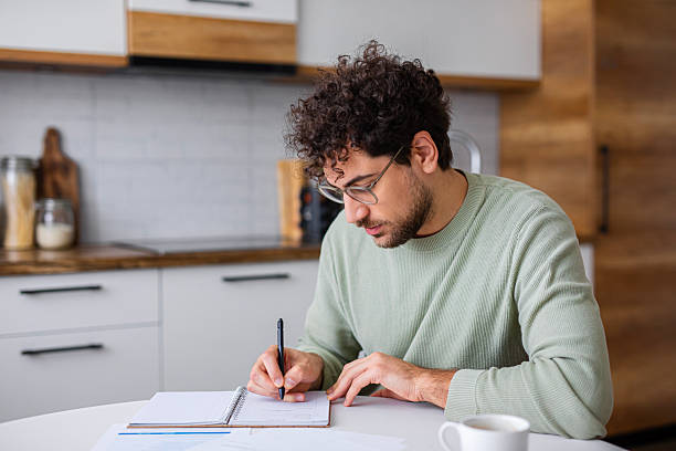 istock Man Analyzing Official Tax Statements at home 2251359998