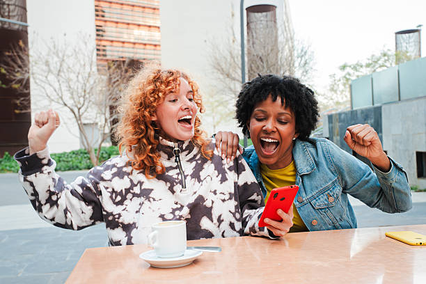 istock Two excited women celebrating a fantastic win while using a smartphone to enjoy a thrilling app experience 2251360017