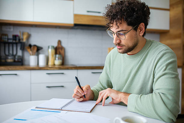 istock Man Analyzing Official Tax Statements at home 2251360387