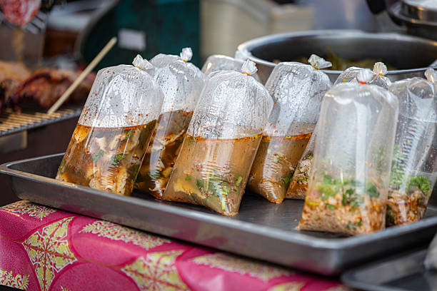 Asian-style soups sales in plastic bags on Asian street food market stall.Phuket Island - Thailand.