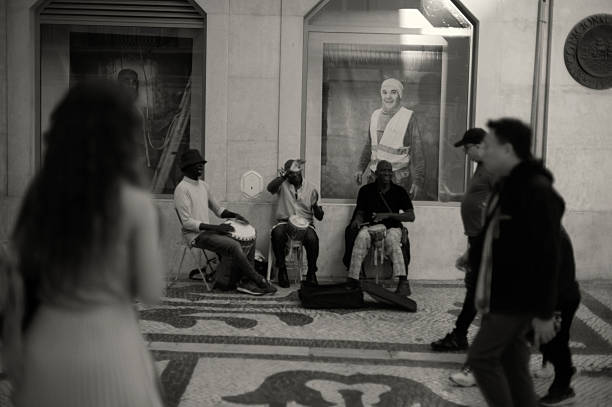 Lisbon, Portugal - November 2, 2024: A trio of african street musicians play percussion at the Rua augusta street in Lisbon downtown.
