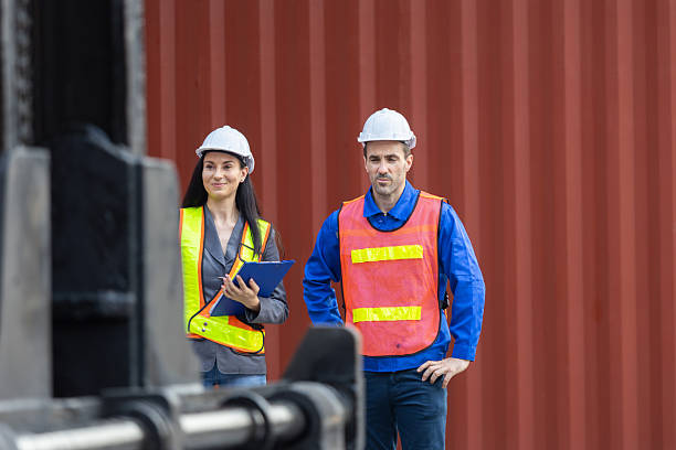 istock Professional Logistic Manager Team Standing Confidently in Front of Cargo, Industrial Engineers and Supervisors Ready for Inspection at Container Port 2251363961