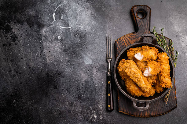 istock Fried chicken fillet tender strips. wooden background. top view 2251364047