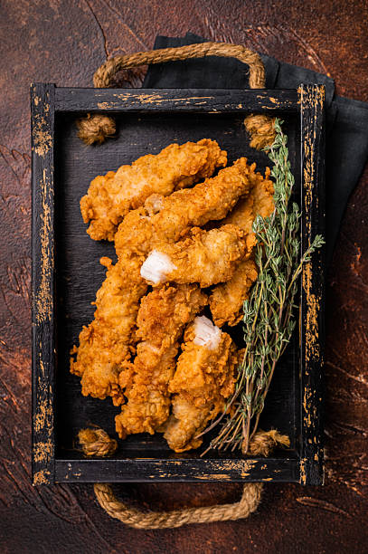 istock Homemade Deep Fried chicken tenders or strips. brown  background. top view 2251365826