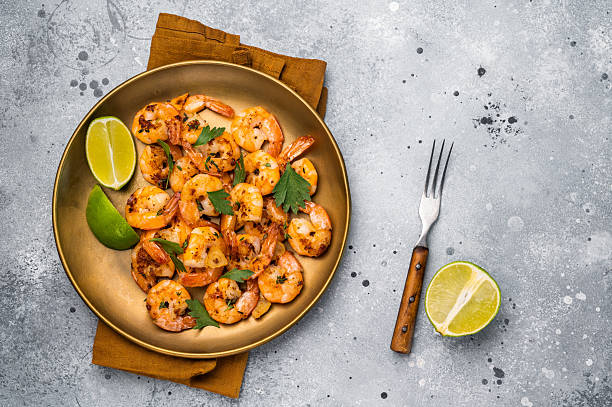 istock BBQ dinner with roast Shrimps Prawns in a plate. Gray background. Top view 2251366961